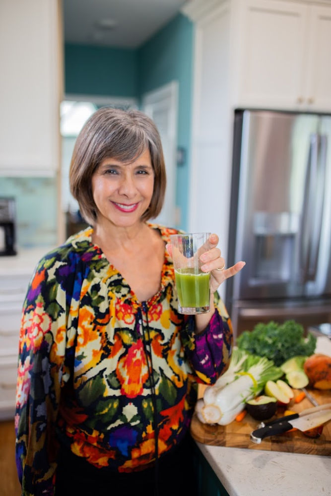 Andrea-holding-up-greeen-drink